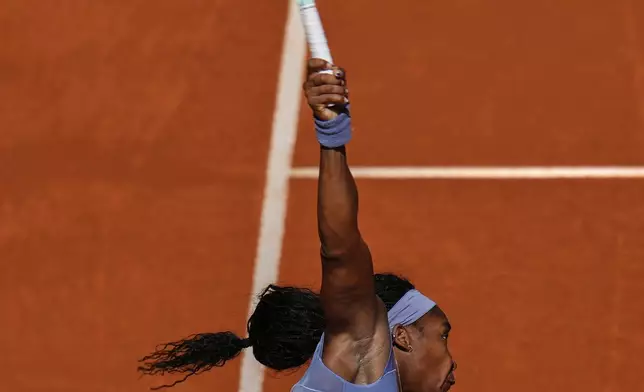 United States' Coco Gauff serves against Iga Swiatek of Poland during the Madrid Open tennis tournament in Madrid, Spain, Thursday, May 1, 2025. (AP Photo/Manu Fernandez)