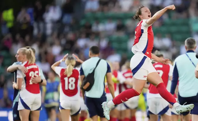Arsenal players celebrate after winning the women's Champions League final soccer match between Arsenal and FC Barcelona at the Jose Alvalade Stadium in Lisbon, Saturday, May 24, 2025. (AP Photo/Jose Breton)