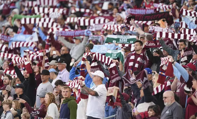 Spectators cheer as the Colorado Rapids take the pitch to face Real Salt Lake in an MLS soccer match Saturday, May 17, 2025, in Commerce City, Colo. (AP Photo/David Zalubowski)