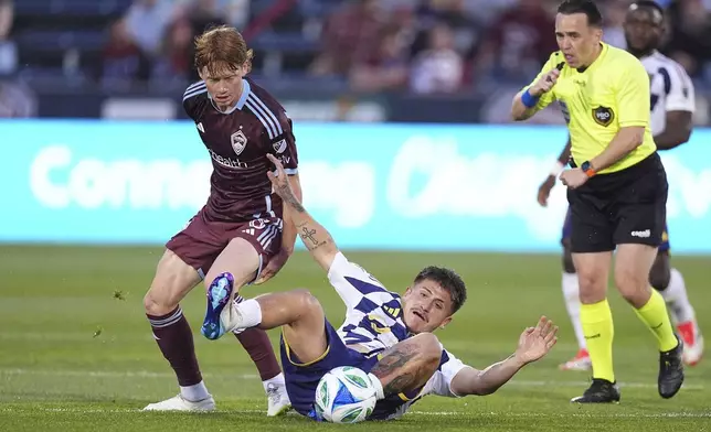 Colorado Rapids midfielder Oliver Larraz, left, collides with Real Salt Lake midfielder Diego Luna, center, while in pursuit of the ball in the first half of an MLS soccer match Saturday, May 17, 2025, in Commerce City, Colo. (AP Photo/David Zalubowski)