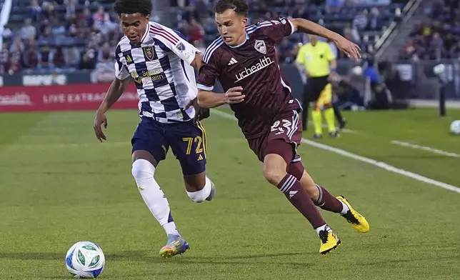 Colorado Rapids midfielder Cole Bassett, right, drives past Real Salt Lake forward Zavier Gozo, left, in the first half of an MLS soccer match Saturday, May 17, 2025, in Commerce City, Colo. (AP Photo/David Zalubowski)