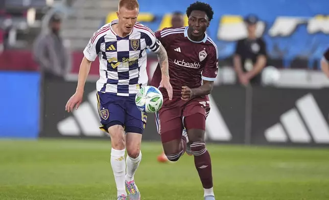 Real Salt Lake defender Justen Glad, left, pursues the ball with Colorado Rapids forward Darren Yapi, right, in the first half of an MLS soccer match Saturday, May 17, 2025, in Commerce City, Colo. (AP Photo/David Zalubowski)