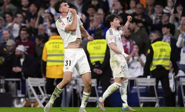 Real Madrid's Jacobo Ramon, left, celebrates with Fran Garcia after scoring his side's second goal during a Spanish La Liga soccer match between Real Madrid and Mallorca in Madrid, Spain, Wednesday, May 14, 2025. (AP Photo/Manu Fernandez)