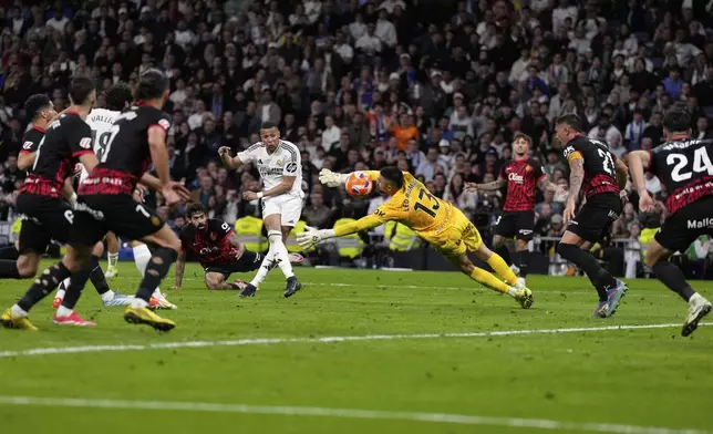 Real Madrid's Kylian Mbappe, centre left, shoots on goal during a Spanish La Liga soccer match between Real Madrid and Mallorca in Madrid, Spain, Wednesday, May 14, 2025. (AP Photo/Manu Fernandez)