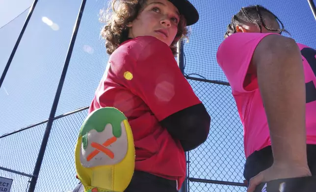 CORRECTS SPELLING TO COLES NOT COLE Youth ballplayer Grayson Coles, left, waits for his game to get underway with his Savannah Banana sliding mitt in his back pocket on April 27, 2025 in Monroeville, Pa. (AP Photo/Gene J. Puskar)