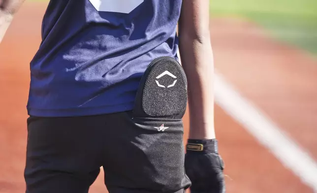 Youth ballplayer Josiah Jones bats during youth baseball game in Monroeville, Pa., with his sliding matt in his back pocket on April 27, 2025. (AP Photo/Gene J. Puskar)