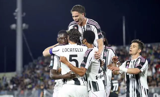 Juventus' Randal Kolo Muani, left, celebrates with team-mates after scoring their side's second goal of the game during the Serie A soccer match between Venezia and Juventus at the Pier Luigi Penzo Stadium, in Venice, Italy, Sunday, May 25, 2025. (Paola Garbuio/LaPresse via AP)