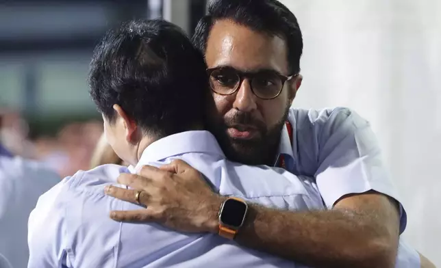 Singapore opposition leader and Workers' Party (WP) Secretary-General, Pritam Singh shares a hug with party member, Jamus Lim at the assembly centre during the general election in Singapore, Saturday, May 3, 2025. (AP Photo/Suhaimi Abdullah)