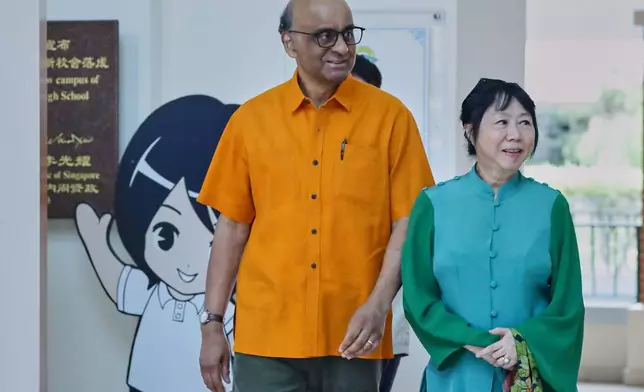 President of Singapore, Tharman Shanmugaratnam and his wife Jane Yumiko Ittogi leave the polling station after casting their votes during the general election in Singapore, Saturday, May 3, 2025. (AP Photo/Suhaimi Abdullah)