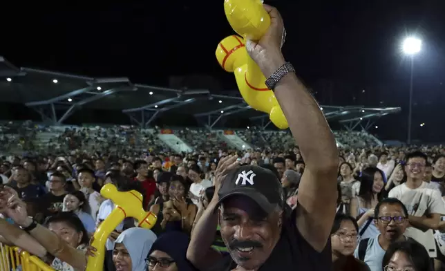 Workers' Party (WP) supporters react at an assembly centre during the general election, in Singapore, Saturday, May 3, 2025. (AP Photo/Suhaimi Abdullah)