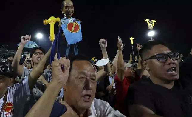 Workers' Party (WP) supporters react at an assembly centre during the general election, in Singapore, Saturday, May 3, 2025. (AP Photo/Suhaimi Abdullah)