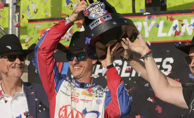 Joey Logano holds the Wurth 400 trophy in Victory Lane after winning a NASCAR Cup Series auto race at Texas Motor Speedway in Fort Worth, Texas, Sunday, May 4, 2025. (AP Photo/Larry Papke)