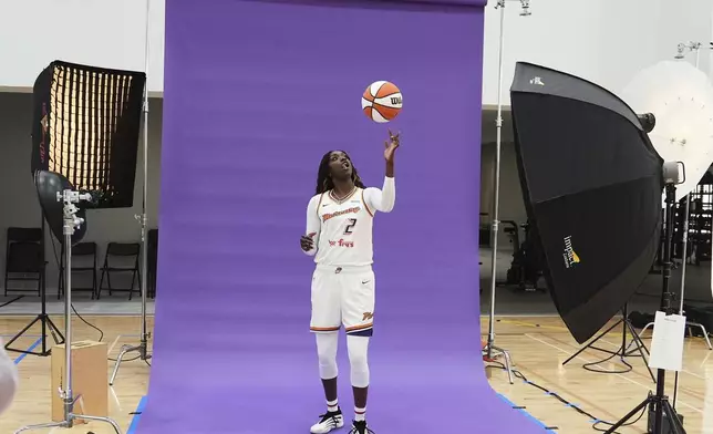 Phoenix Mercury guard-forward Kahleah Copper flips the ball in the air during a photo shoot at Mercury Media Day at the team's WNBA basketball training facility, Wednesday, April 30, 2025, in Phoenix. (AP Photo/Ross D. Franklin)