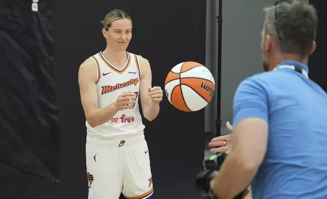 Phoenix Mercury guard Sami Whitcomb, left, of Australia, reaches for a ball tossed to her during a photo shoot at Mercury Media Day at the team's WNBA basketball training facility, Wednesday, April 30, 2025, in Phoenix. (AP Photo/Ross D. Franklin)