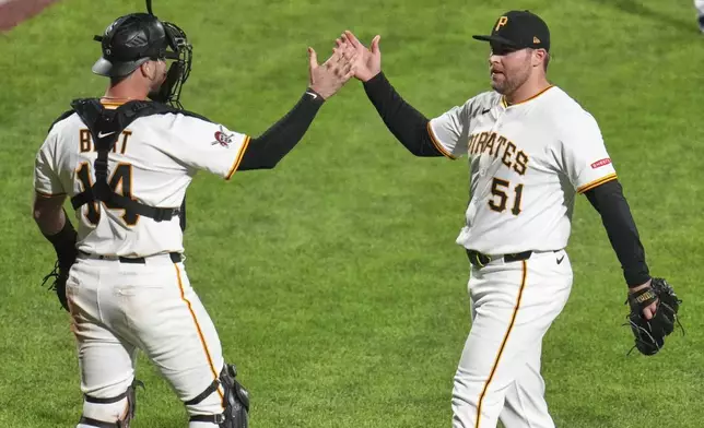 Pittsburgh Pirates pitcher David Bednar (51) celebrates with catcher Joey Bart after getting the final out of a baseball game against the Chicago Cubs in Pittsburgh, Wednesday, April 30, 2025. (AP Photo/Gene J. Puskar)