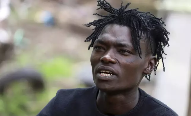 Ben Gachege, a reformed gangster and a member of Vision Bearerz Youth Group, gesturers during an interview with the associated press in the Mathare informal settlement of the capital Nairobi, Kenya Saturday, April 5, 2025. (AP Photo/Andrew Kasuku)