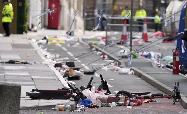 Scooters lie on the site where a 53-year-old British man plowed a minivan into a crowd of Liverpool soccer fans who were celebrating the city's Premier League championship Monday, injuring more than 45 people in Liverpool, England, Tuesday, May 27, 2025.(AP Photo/Jon Super)