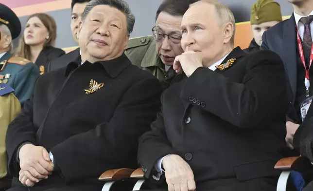 Russian President Vladimir Putin, right, and Chinese President Xi Jinpin watch the Victory Day military parade in Moscow, Russia, Friday, May 9, 2025, during celebrations of the 80th anniversary of the Soviet Union's victory over Nazi Germany during the World War II. (Mikhail Korytov/Photo host agency RIA Novosti via AP)