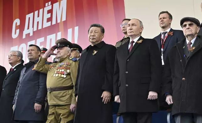 Russian President Vladimir Putin, centre right, and Chinese President Xi Jinpin, centre, watch the Victory Day military parade in Moscow, Russia, Friday, May 9, 2025, during celebrations of the 80th anniversary of the Soviet Union's victory over Nazi Germany during the World War II. (Mikhail Korytov/Photo host agency RIA Novosti via AP)