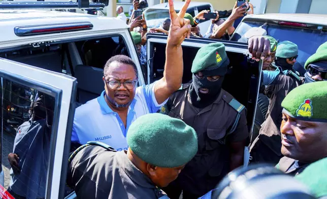 CAPTION CORRECTS THE SPELLING - Tanzania's main opposition leader Tundu Lissu, centre, gestures as he arrive at Kisutu magistrate's court in Dar es Salaam, Tanzania Monday, May 19, 2025. (AP Photo/Derick Katunzi)