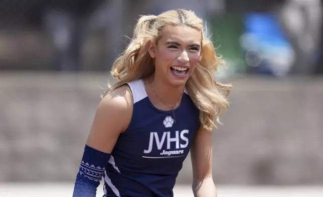 AB Hernandez of Jurupa Valley smiles while completing in the girls long jump during the CIF Southern Section Masters Meet at Moorpark High School, Saturday, May 24, 2025, in Moorpark, Calif. (Kirby Lee via AP)