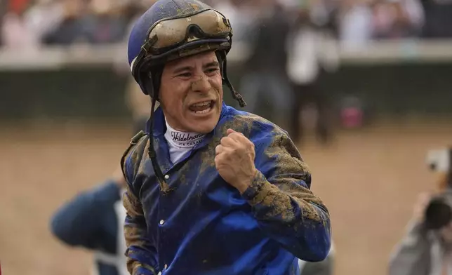 Jockey Junior Alvarado celebrates after riding Sovereignty to victory in the 151st running of the Kentucky Derby horse race at Churchill Downs Saturday, May 3, 2025, in Louisville, Ky. (AP Photo/Abbie Parr)