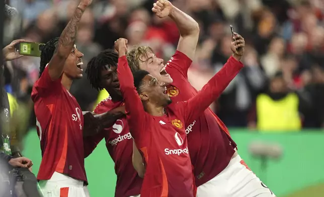 Manchester United's Rasmus Hojlund, back right, celebrates with teammates after scoring their side's third goal of the gameduring the Europa League semifinal second leg soccer match between Manchester United and Athletic Bilbao in Manchester, Britain, Thursday, May 8, 2025. (Martin Rickett/PA via AP)