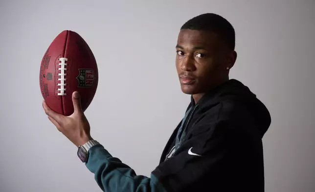 Philadelphia Eagles DeVonta Smith holds the ball as he poses for a photo ahead of an interview with the Associated Press in Barcelona, Spain, Monday, May 12, 2025. (AP Photo/Emilio Morenatti)