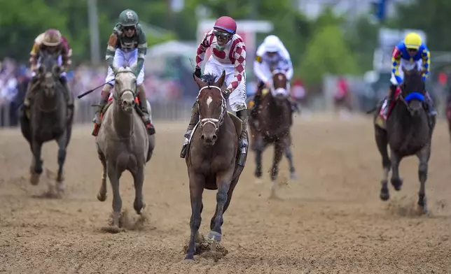 Umberto Rispoli, atop Journalism, reacts after winning the the 150th running of the Preakness Stakes horse race Saturday, May 17, 2025, at Pimlico Race Course in Baltimore. (AP Photo/Nick Wass)