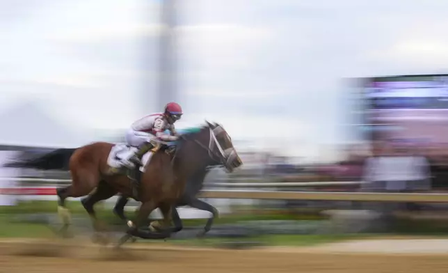 Umberto Rispoli, front atop Journalism, edges out Luis Saez, atop Gosger, to win during the 150th running of the Preakness Stakes horse race Saturday, May 17, 2025, at Pimlico Race Course in Baltimore. (AP Photo/Julio Cortez)