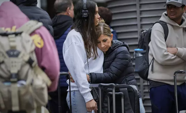 Travelers wait for news about their delayed trains at the Madrid train station, Spain, Monday, May 5, 2025. (AP Photo/Manu Fernandez)