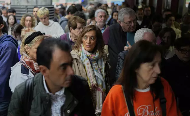 Travelers wait on the platforms for news about their delayed trains at the Madrid train station, Spain, Monday, May 5, 2025. (AP Photo/Manu Fernandez)