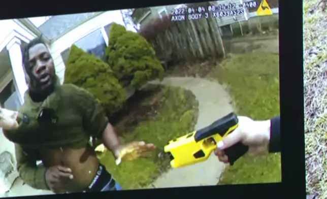 Body worn camera footage showing former Grand Rapids Police officer Christopher Schurr with a Taser7 and Patrick Lyoya is shown during the third day at the Kent County Courthouse with his wife Brandey in Grand Rapids, Mich. on Wednesday, April 30, 2025. (Joel Bissell/Kalamazoo Gazette via AP)