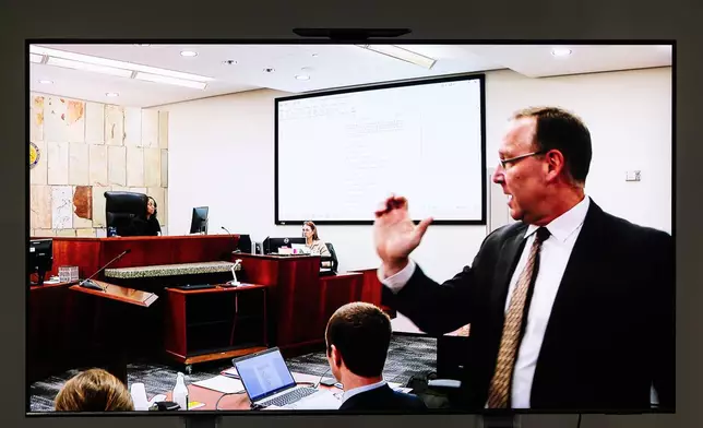 Kent County Prosecutor Chris Becker cross-examines David Siver, GRPD Capt., as he testifies during the fourth day of trial for former Grand Rapids Police officer Christopher Schurr, who is charged with second-degree murder in the fatal shooting of Patrick Lyoya, a Congolese immigrant, during a traffic stop, at the Kent County Courthouse in Grand Rapids, Mich., Thursday, May 1, 2025. (Joel Bissell/MLive.com/Kalamazoo Gazette via AP)