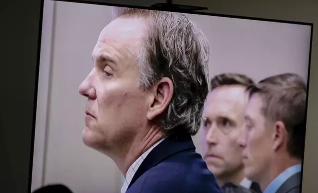Defense attorney Matthew Borgula listens as Judge Christina Mims addresses the courtroom during the fourth day of trial for former Grand Rapids Police officer Christopher Schurr, who is charged with second-degree murder in the fatal shooting of Patrick Lyoya, a Congolese immigrant, during a traffic stop, at the Kent County Courthouse in Grand Rapids, Mich., Thursday, May 1 2025. (Joel Bissell/MLive.com/Kalamazoo Gazette via AP)
