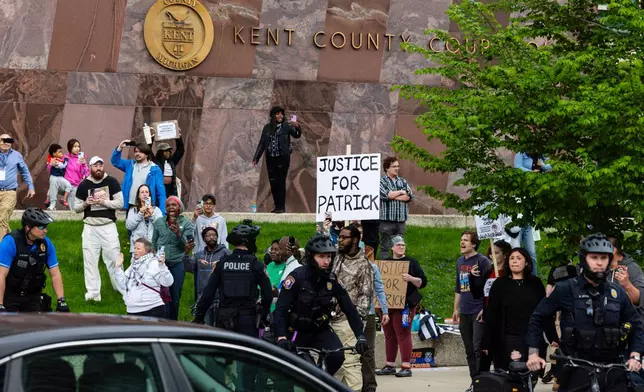 Police divide supporters of former Grand Rapids Police officer Christopher Schurr, who is charged with second-degree murder in the fatal shooting of Patrick Lyoya, a Congolese immigrant, and Lyoya outside the Kent County Courthouse in Grand Rapids, Mich., Tuesday, May 6, 2025. (Joel Bissell/MLive.com/Kalamazoo Gazette via AP)