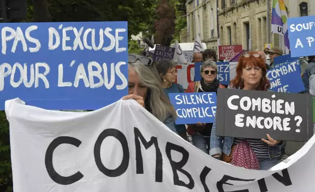 People demonstrate with posters reading "No excuse for abuses", left, and "How many more?", right, ahead of the verdict in the trial of Joel Le Scouarnec, a 74-year-old former surgeon, accused of raping and sexually assaulting 299 children, Wednesday, May 28, 2025 in Vannes, Brittany, western France. (AP Photo/Mathieu Pattier)