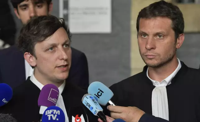 Maxime Tessier, left, and Thibaut Kurzawa, Joel Le Scouarnec's lawyers, answer reporters after the 74-year-old pedophile and former surgeon who raped hundreds of victims over a period spanning more than two decades was given a maximum 20-year prison sentence Wednesday, May 28, 2025 in Vannes, Brittany, western France. (AP Photo/Mathieu Pattier)