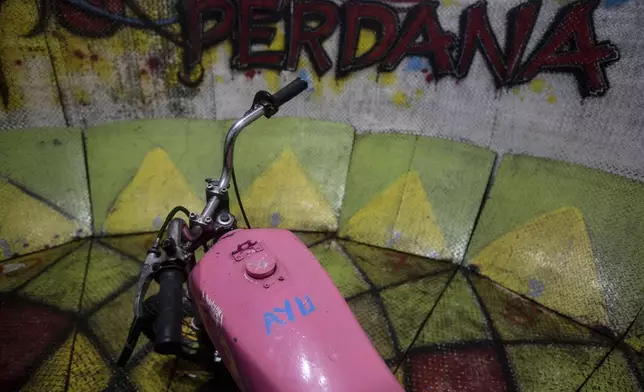 "Ayu," the nickname of "wall of death" rider Sri Wahyuni is painted on the tank of her motorcycle at a fairground in Medan, North Sumatra, Indonesia, Friday, May 9, 2025. (AP Photo/Binsar Bakkara)