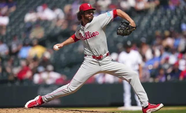 Philadelphia Phillies relief pitcher Jordan Romano throws to the plate during the ninth inning of a baseball game against the Colorado Rockies, Thursday, May 22, 2025, in Denver. (AP Photo/Jack Dempsey)