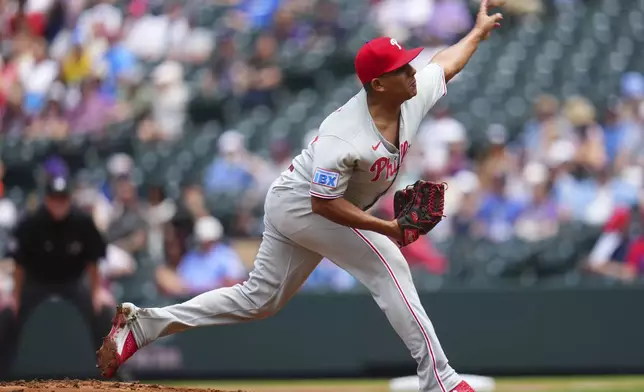 Philadelphia Phillies starting pitcher Ranger Suarez throws to the plate during the first inning of a baseball game against the Colorado Rockies, Thursday, May 22, 2025, in Denver. (AP Photo/Jack Dempsey)