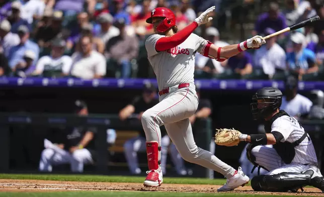 Philadelphia Phillies' Alec Bohm hits a double against the Colorado Rockies during the fifth inning of a baseball game Thursday, May 22, 2025, in Denver. (AP Photo/Jack Dempsey)