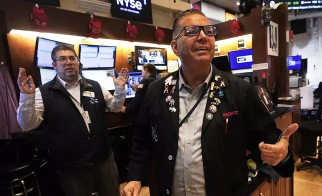 Traders Jonathan Mueller, right, and Michael Capolino work on the floor of the New York Stock Exchange, Wednesday, May 14, 2025. (AP Photo/Richard Drew)