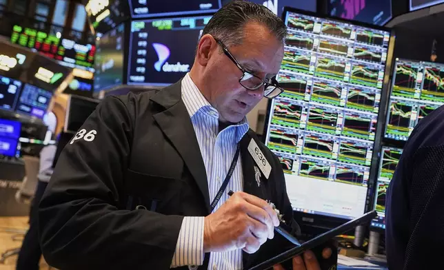 Trader Edward Curran works on the floor of the New York Stock Exchange, Wednesday, May 14, 2025. (AP Photo/Richard Drew)
