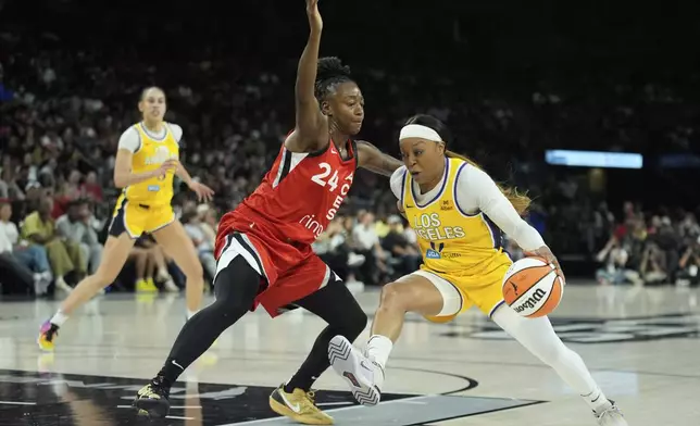Los Angeles Sparks guard Odyssey Sims (0) drives against Las Vegas Aces guard Jewell Loyd (24) during the first half of a WNBA basketball game Friday, May 30, 2025, in Las Vegas. (AP Photo/John Locher)