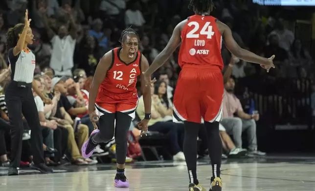 Las Vegas Aces guard Chelsea Gray (12) celebrates after making a 3-point shot against the Los Angeles Sparks during the first half of a WNBA basketball game Friday, May 30, 2025, in Las Vegas. (AP Photo/John Locher)