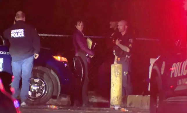 This image made from a video provided by KOMO shows police working at the scene of a shooting at Harry Todd Park in Lakewood, Wash., Wednesday, May 28, 2025. (KOMONEWS.COM via AP)