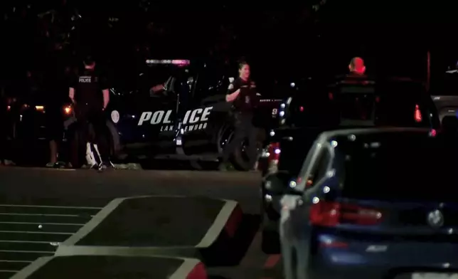 This image made from a video provided by KOMO shows police working at the scene of a shooting at Harry Todd Park in Lakewood, Wash., Wednesday, May 28, 2025. (KOMONEWS.COM via AP)