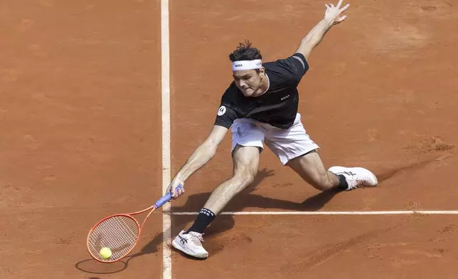 Taylor Fritz of the U.S. returns a ball to Quentin Halys of France during the round of 16, at the ATP 250 Geneva Open Tennis Tournament, in Geneva, Switzerland, Wednesday, May 21, 2025 (Cyril Zingaro/Keystone via AP)