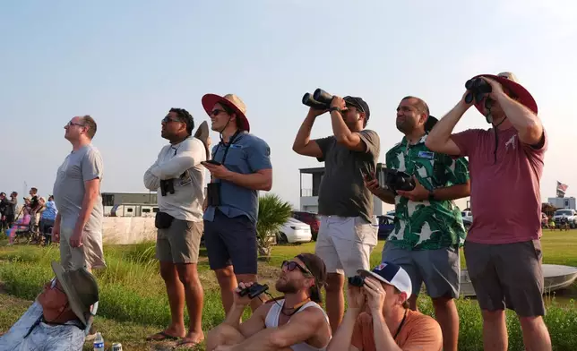 People watch as SpaceX's mega rocket Starship makes a test flight from Starbase, Texas, Tuesday, May 27, 2025. (AP Photo/Eric Gay)